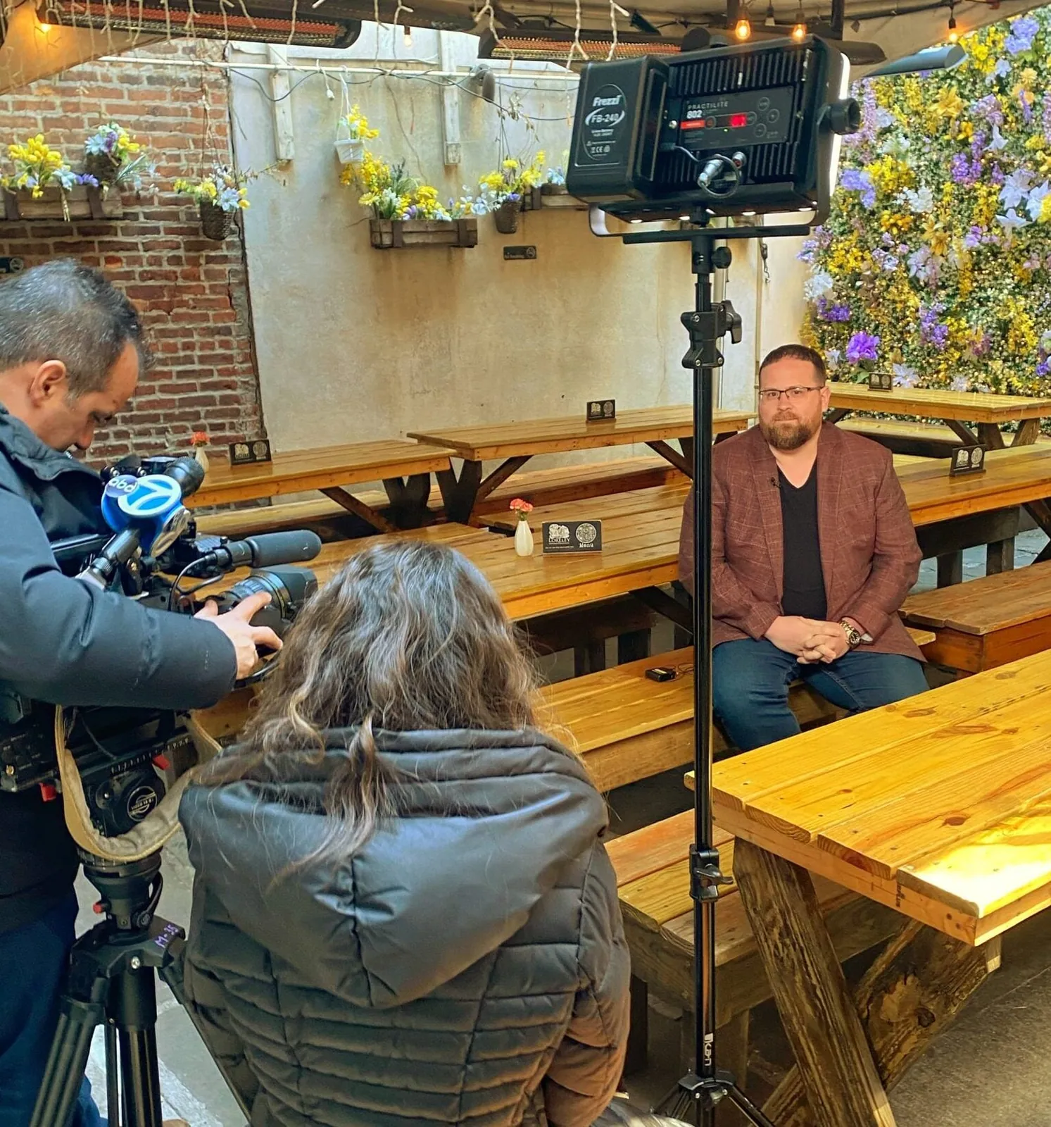 A film crew shooting in a restaurant's beer garden